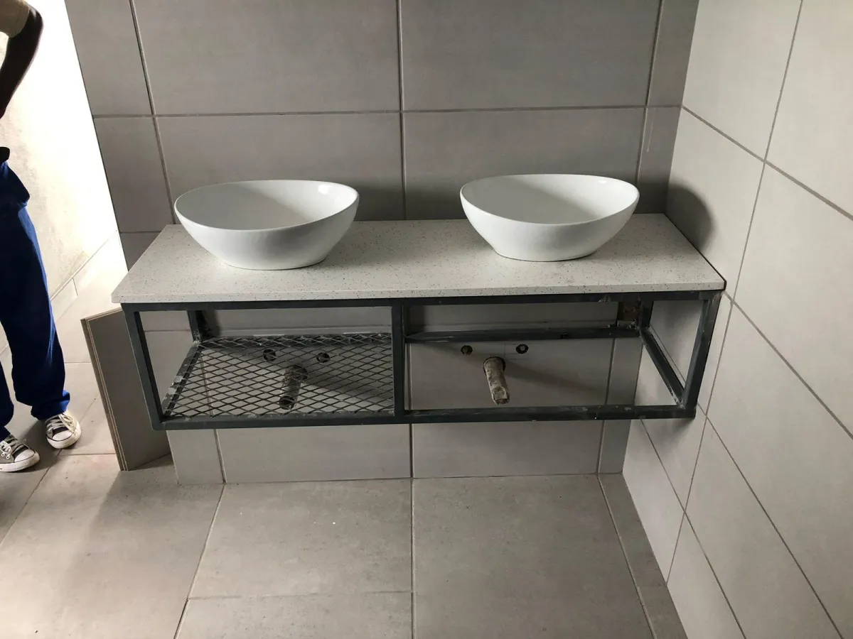 Bathroom vanity with a modern cage-style design and a sleek quartz countertop, combining contemporary style with durable materials