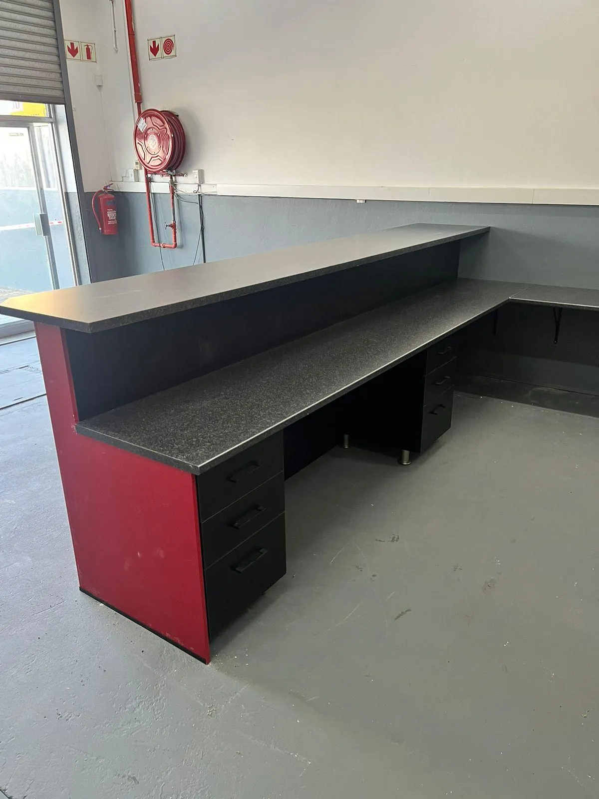 Modular office cupboard units with light red finish..