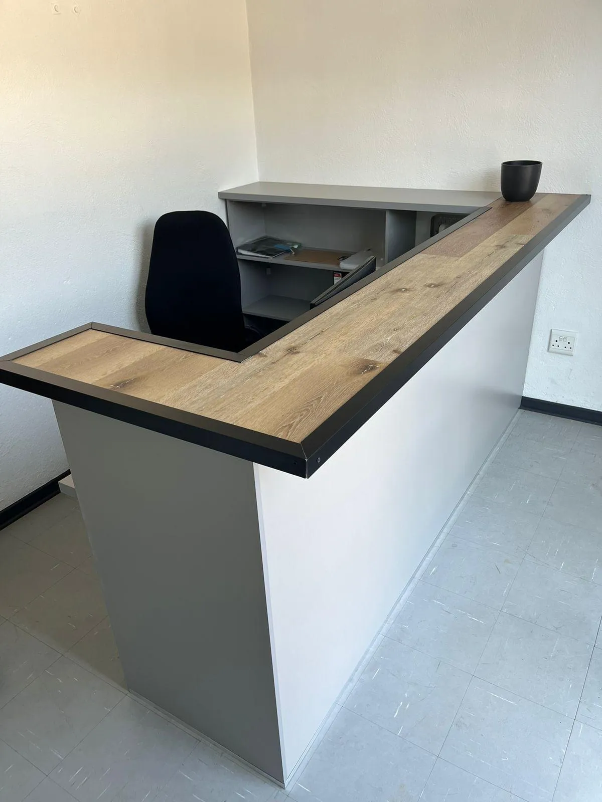Reception desk with built-in filing cabinets.