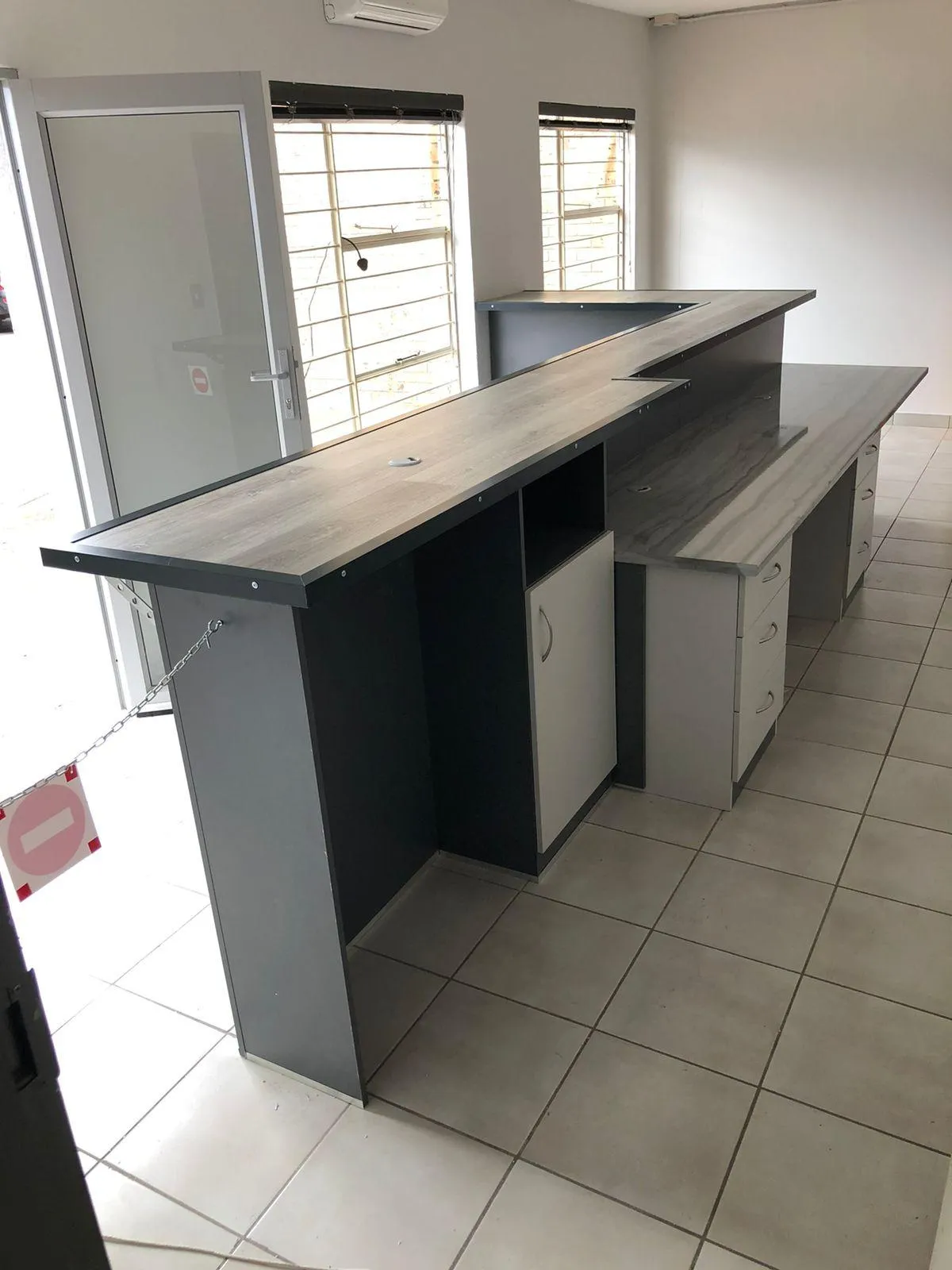 Reception desk with built-in filing cabinets.