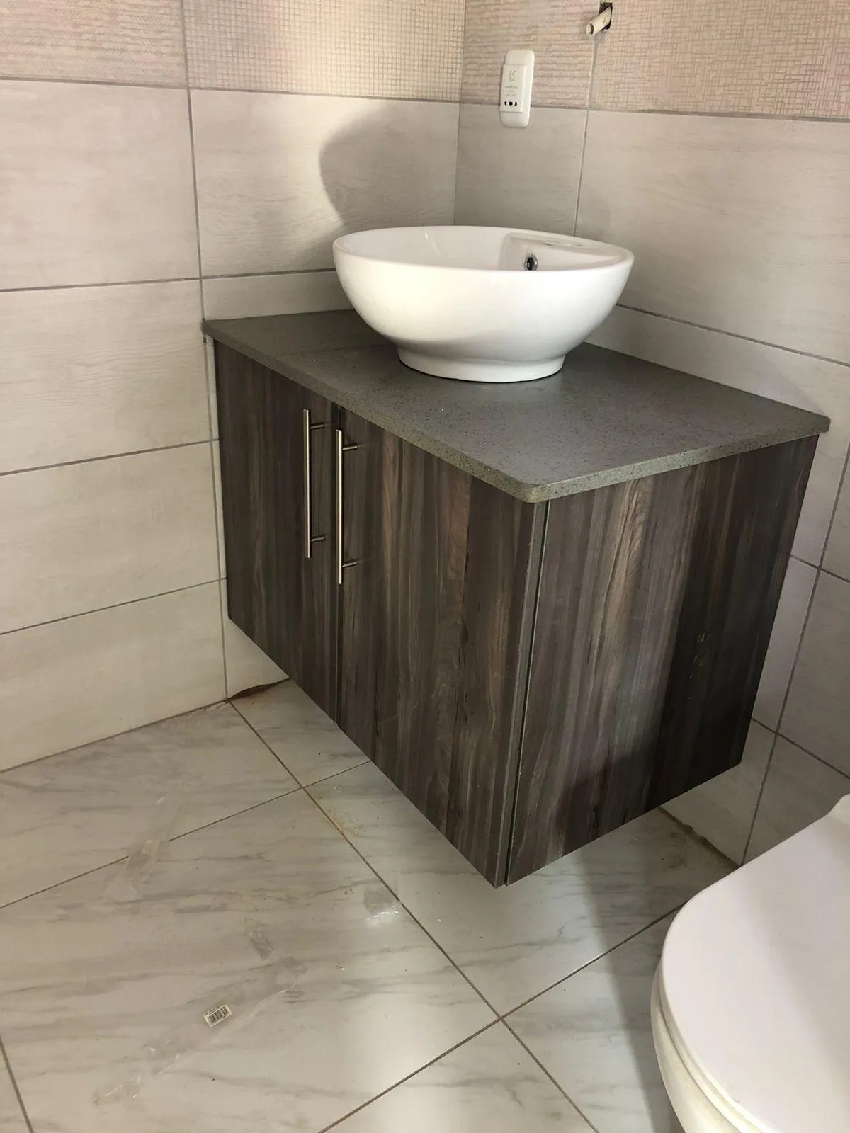 Modern bathroom storage cabinets with durable woody-looking doors and PVC finish