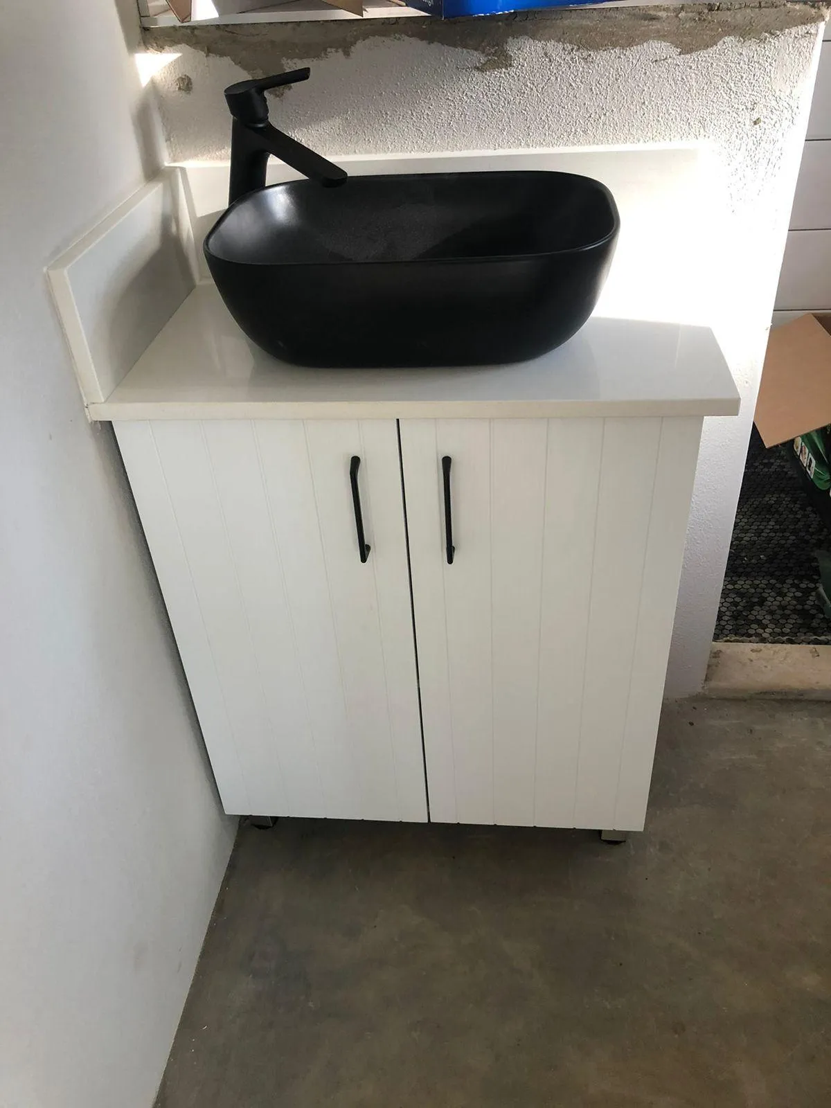 Bathroom vanity unit with Eazi quartz countertop and water-resistant melamine doors.
