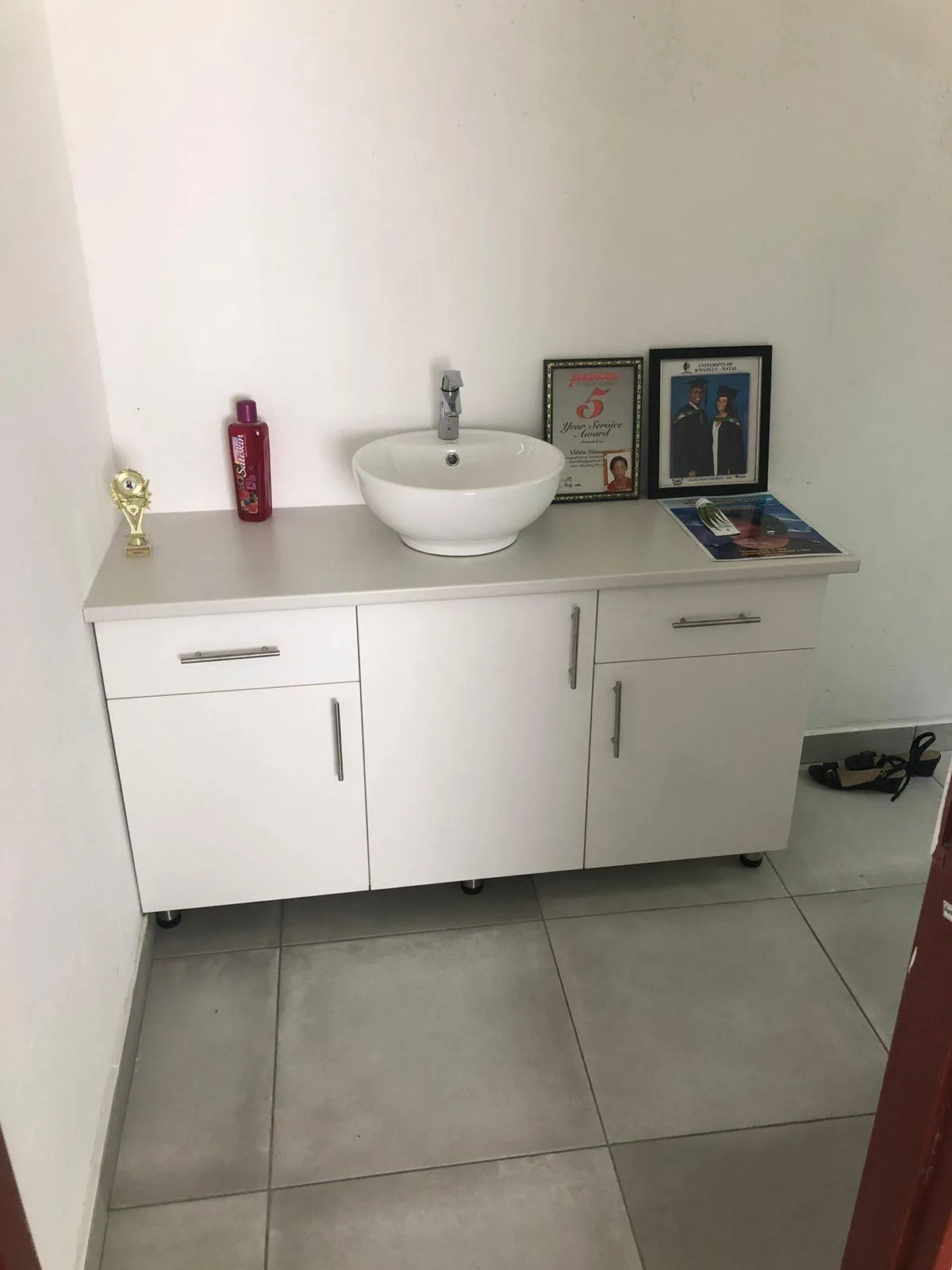 Modern bathroom cabinetry with sleek white melamine doors.