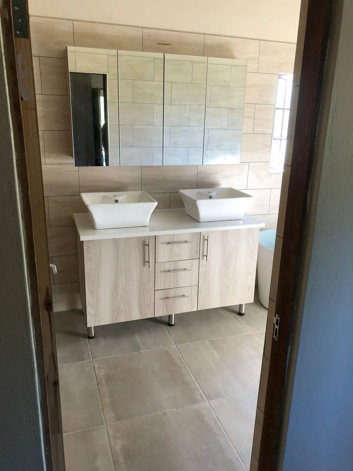 Compact bathroom cabinetry untis with quartz countertops and stylish cabinet handles