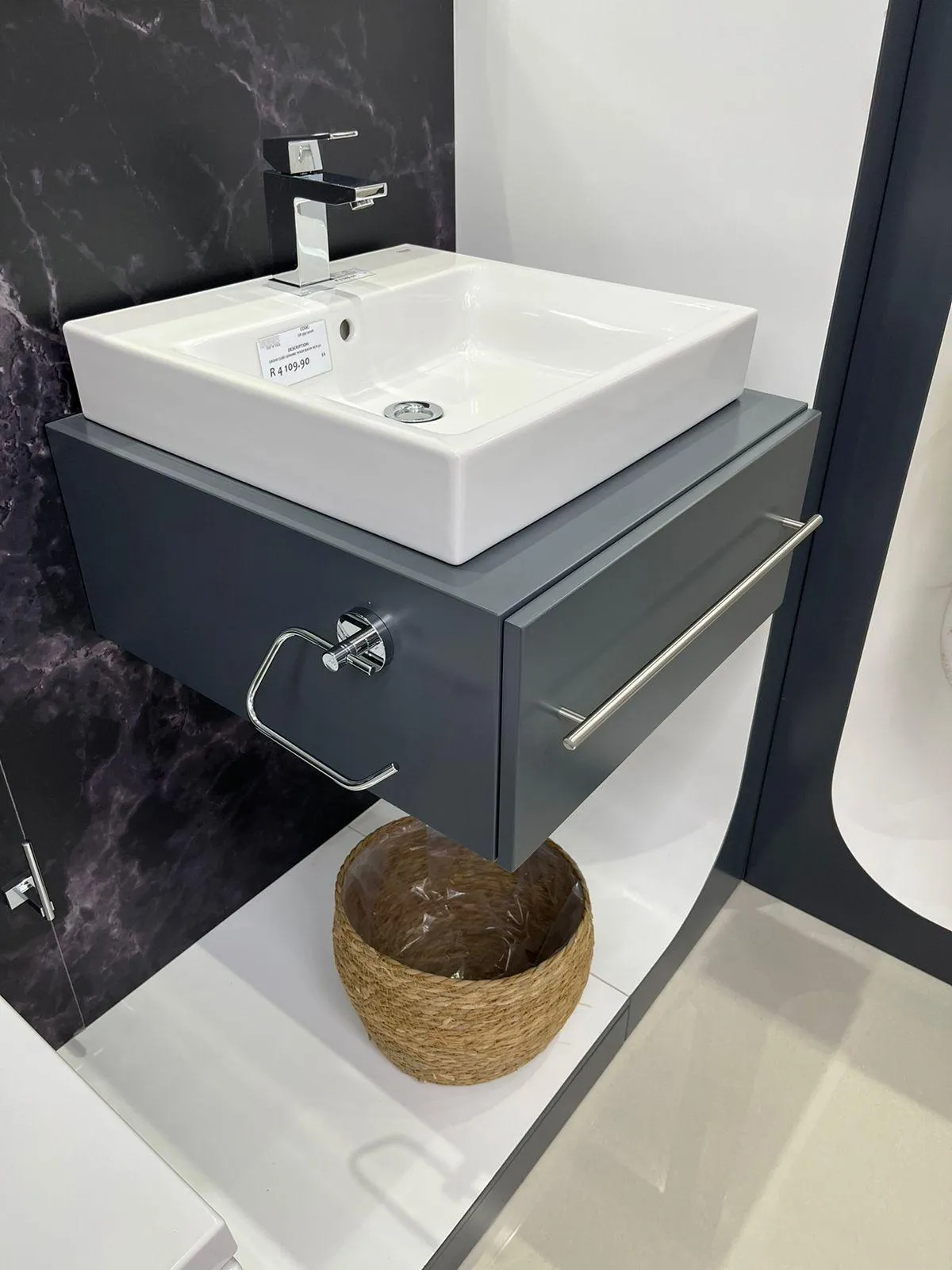 Elegant grey floating unti with waterproof PVC finish in a spacious bathroom.