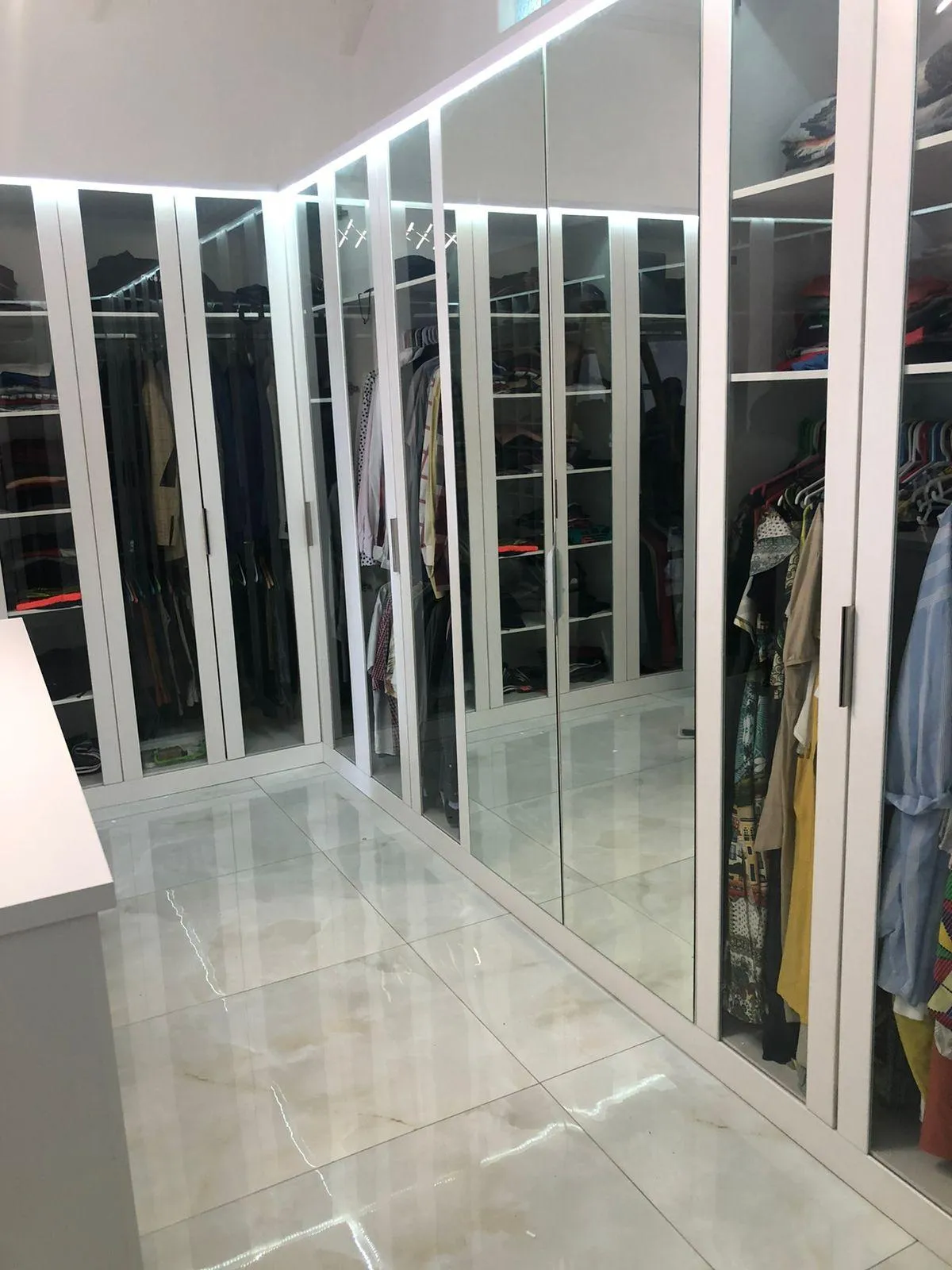 Custom cabinetry with mirrored wardrobe doors