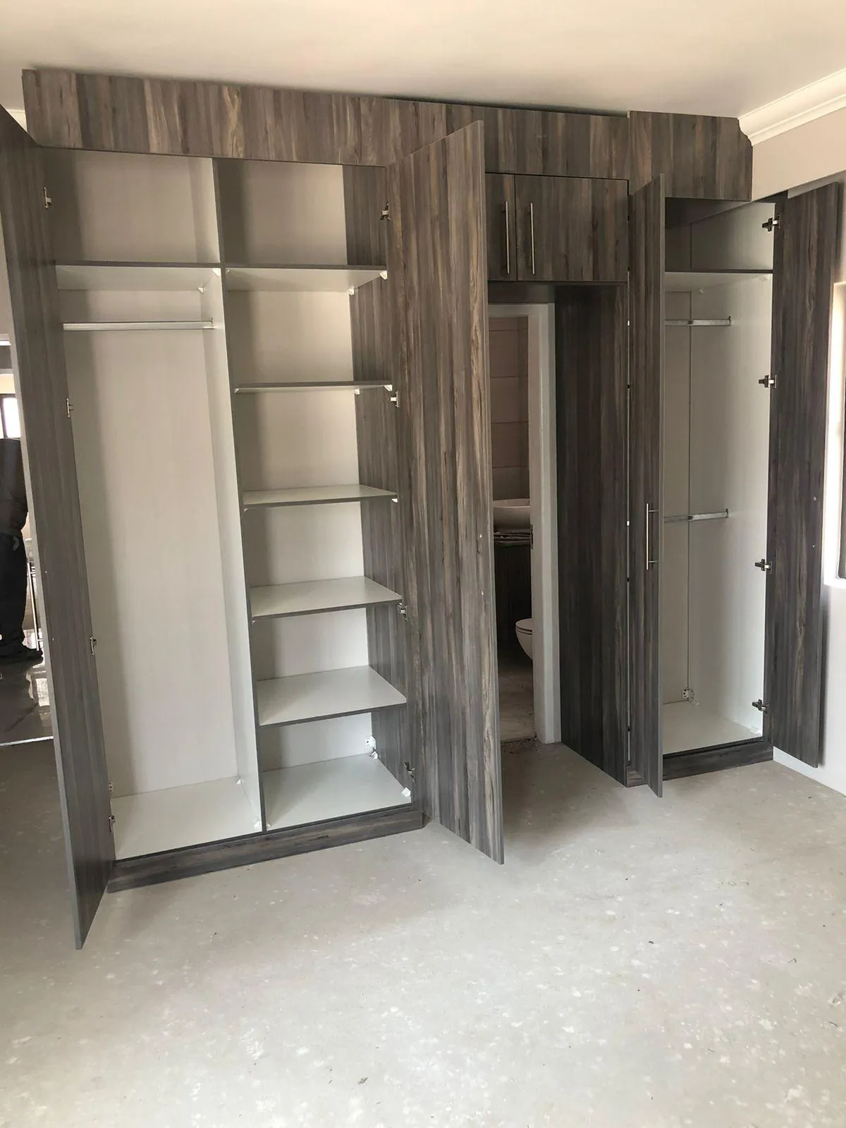 Walk-in closet with custom shelving and hanging space