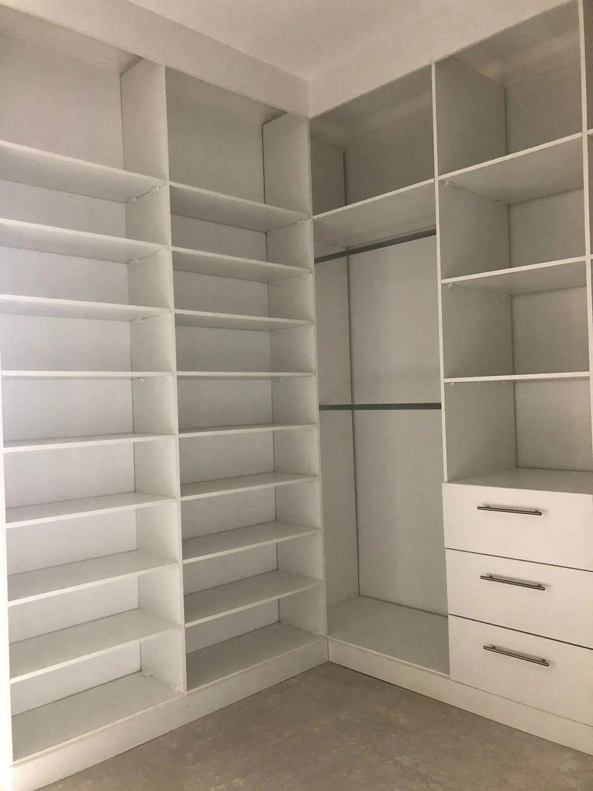Modern white walk-in wardrobe with shoe storage