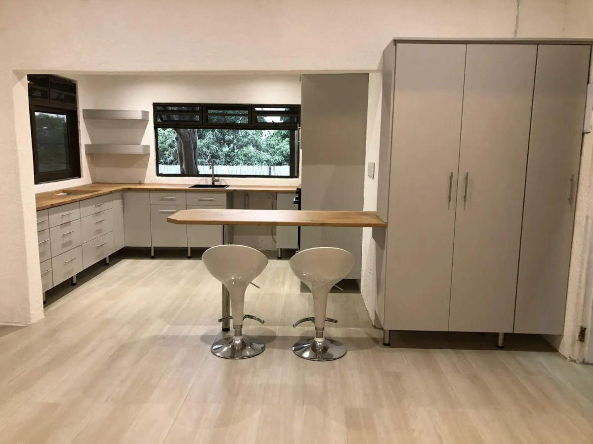 Custom kitchen units with white melamine finishes.