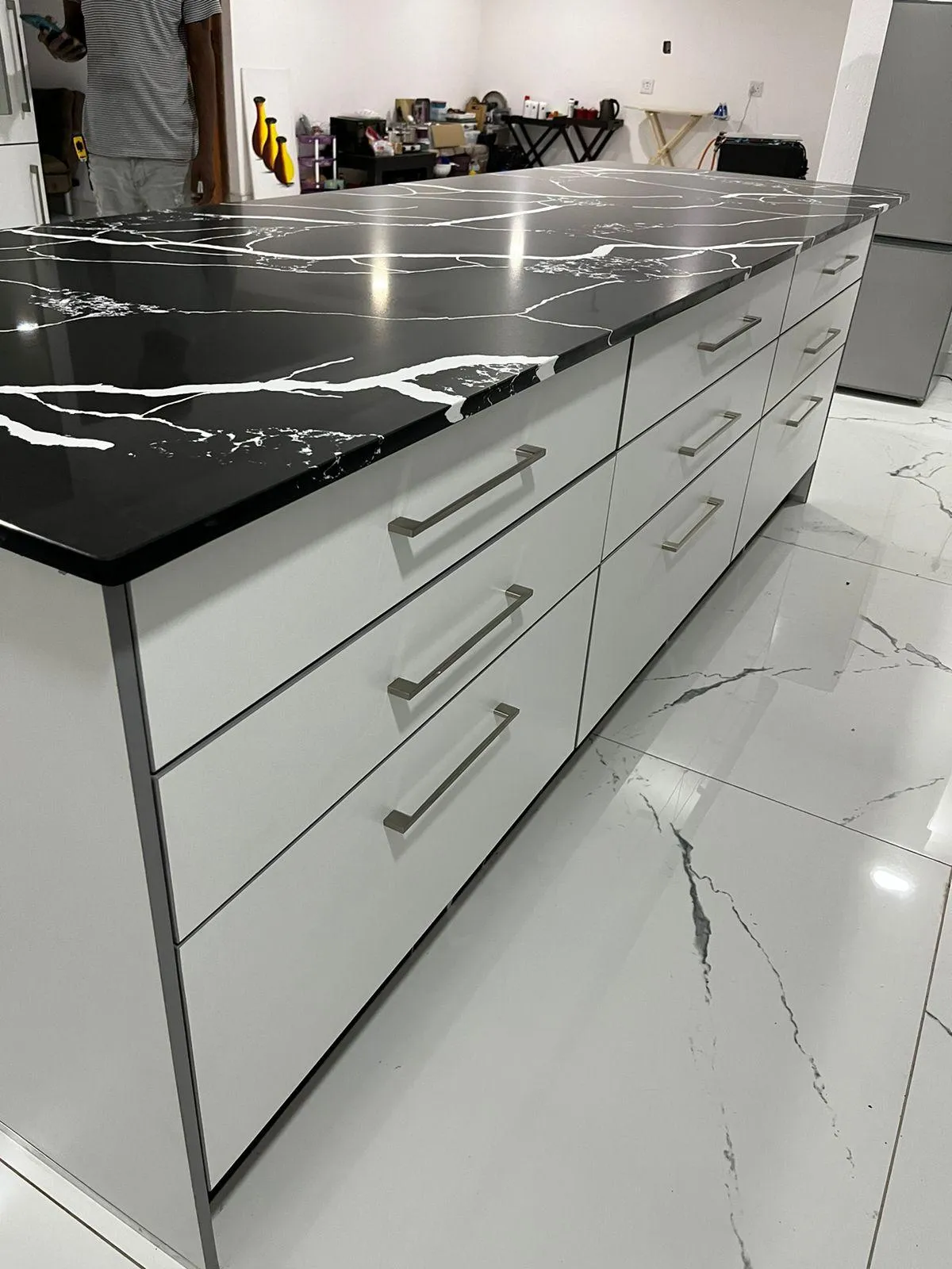 Black and white quartz countertop with white built-in cabinets, featuring a sleek and modern design.
