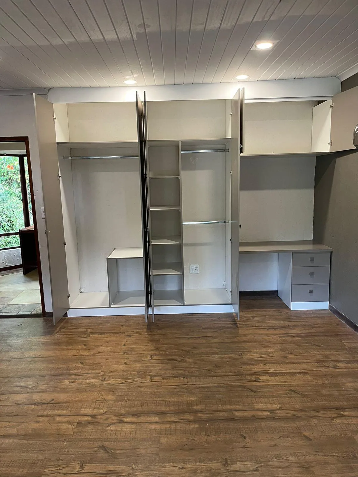Custom wardrobe with built-in study space and shoe storage