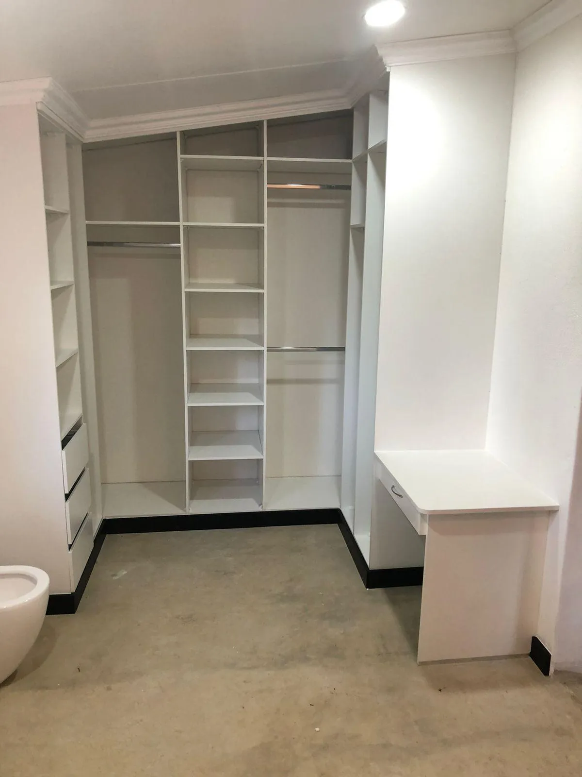 Built-in white wardrobe with study place and hanging space