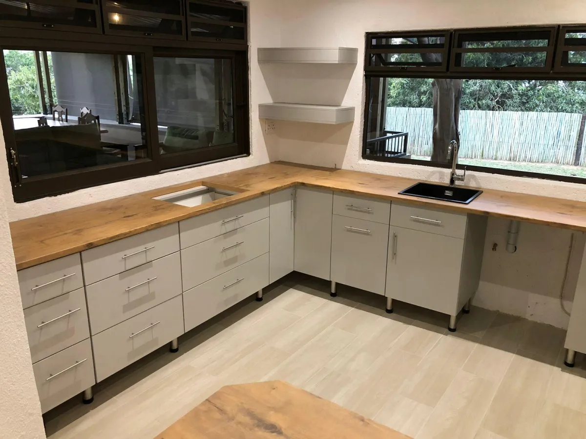 Custom kitchen units with white melamine finishes.