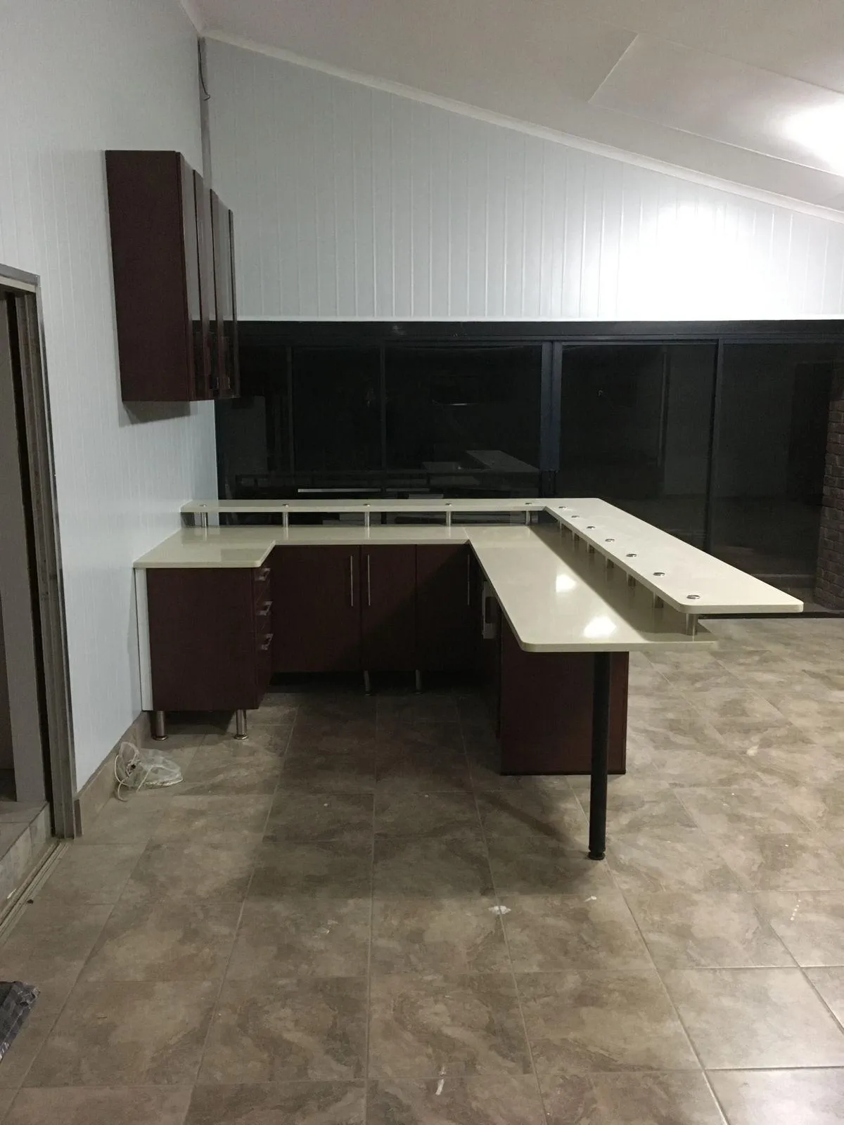 Wooden kitchen cupboards with glass doors.