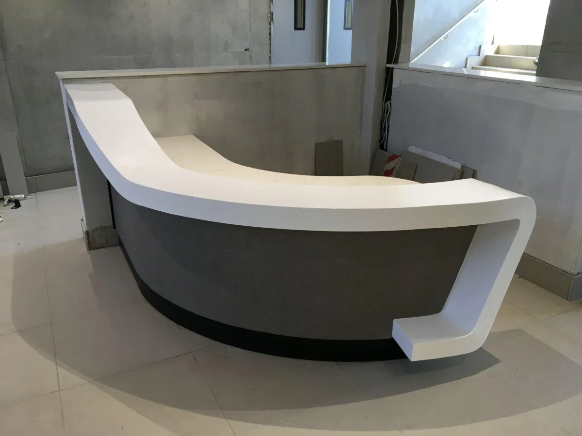 Modern office reception desk with gray and white accents.