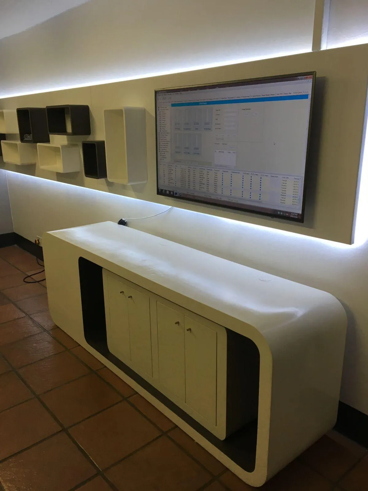 Custom-built office cupboards with a white finish.