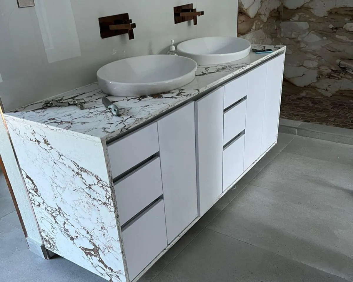 Custom-built bathroom vanity with quartz countertop & white melamine doors.