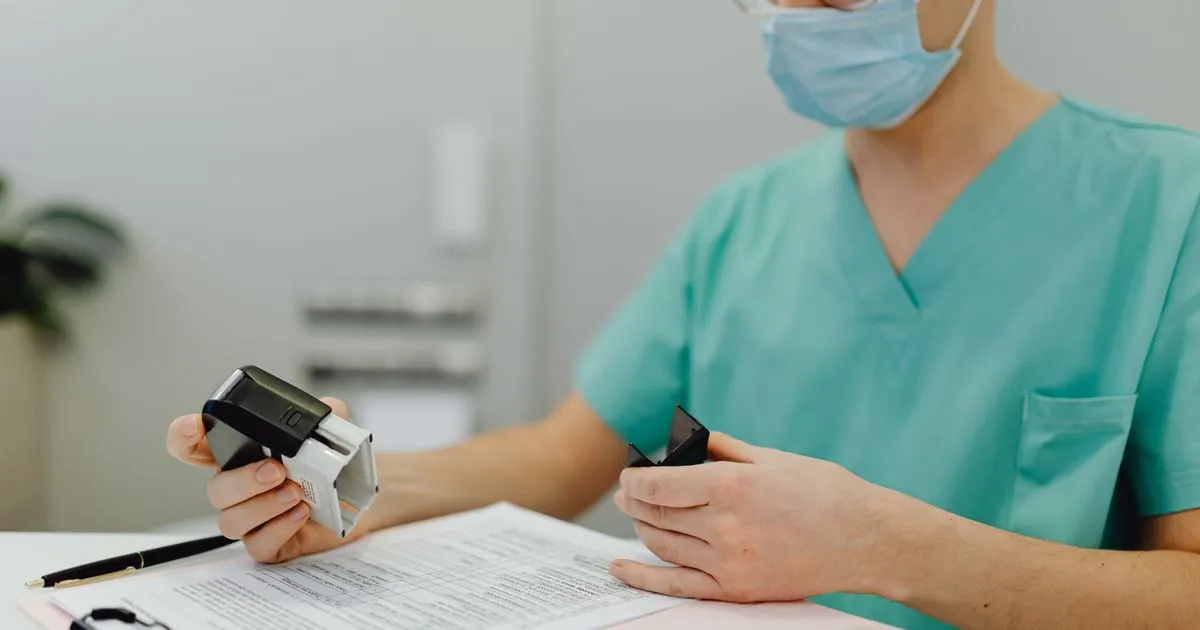 Medical billing staff member reviewing denied insurance claims and patient files at a practice in Tulsa, Oklahoma