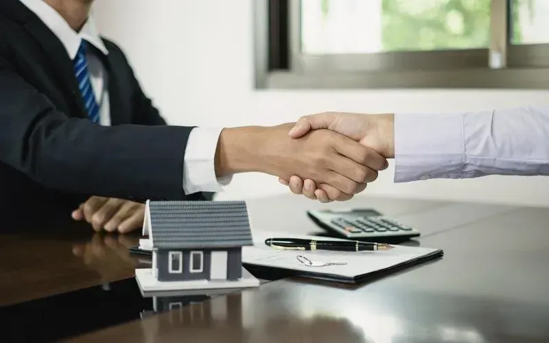 Mortgage advisor meeting with clients in a professional office setting.