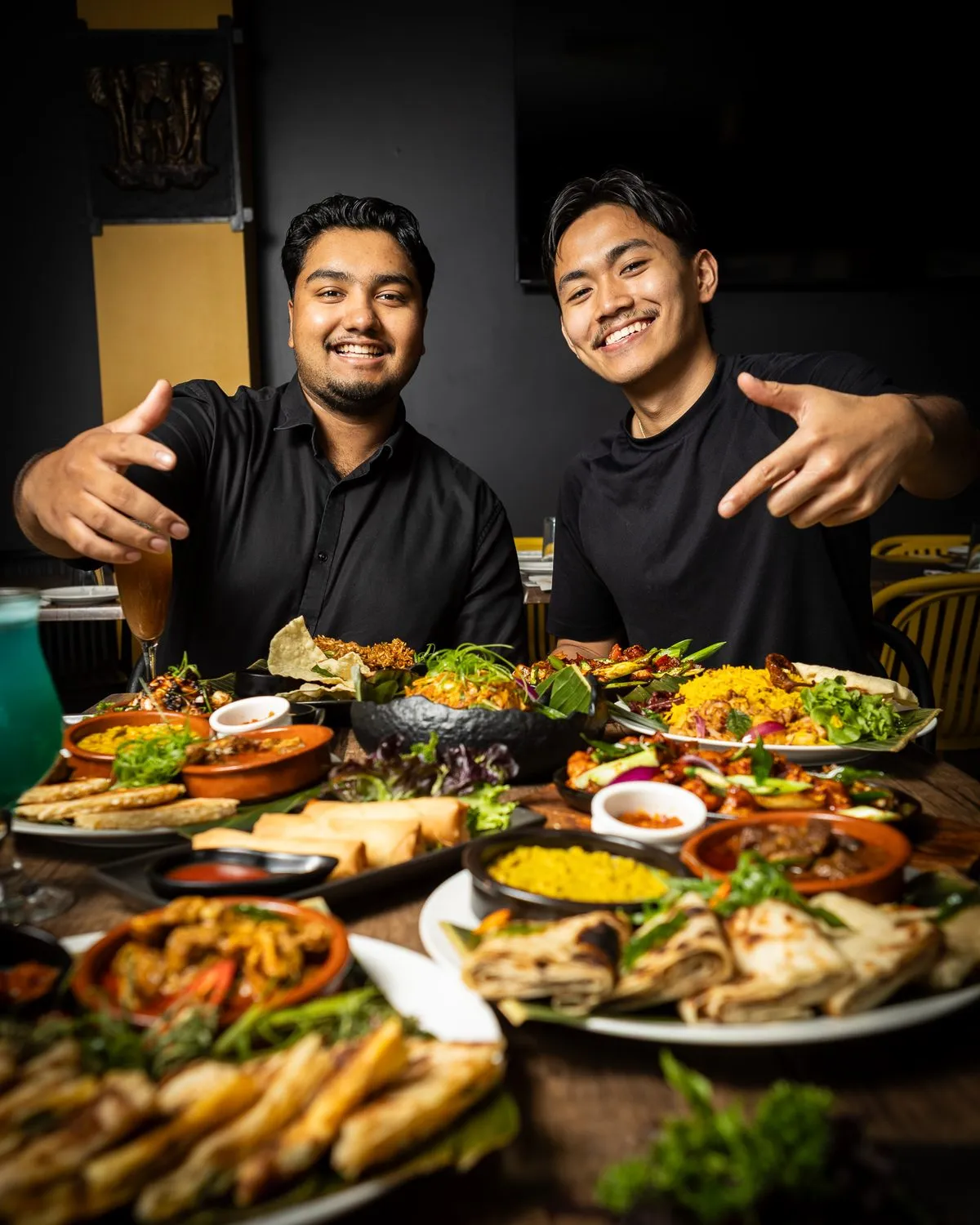 The Walkway to Ceylon team smiling behind a table full of Sri Lankan dishes