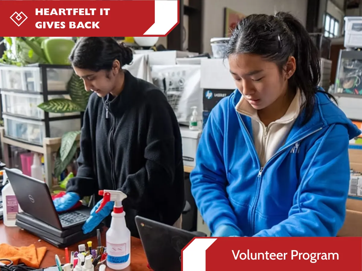 A detailed structured horizontal infographic layout with red and blue banners promoting the HEARTFELT IT VOLUNTEER PROGRAM. The red header banner across the top reads 'HEARTFELT IT GIVE BACK' and 'VOLUNTEER PROGRAM' with the diamond-heart logo. The central information panel features a group of five diverse illustrated technology professionals (smiling) and provides the program details: 'Nonprofits desperately need professional IT support to protect data and stay efficient. ... As a volunteer, you will become a digital steward, donating a few hours of expertise...' with a green bulleted list of benefits: '♻️ TANGIBLE IMPACT,' '📈 GROW YOUR NETWORK,' and '🤝 FLEXIBLE STEWARDSHIP'