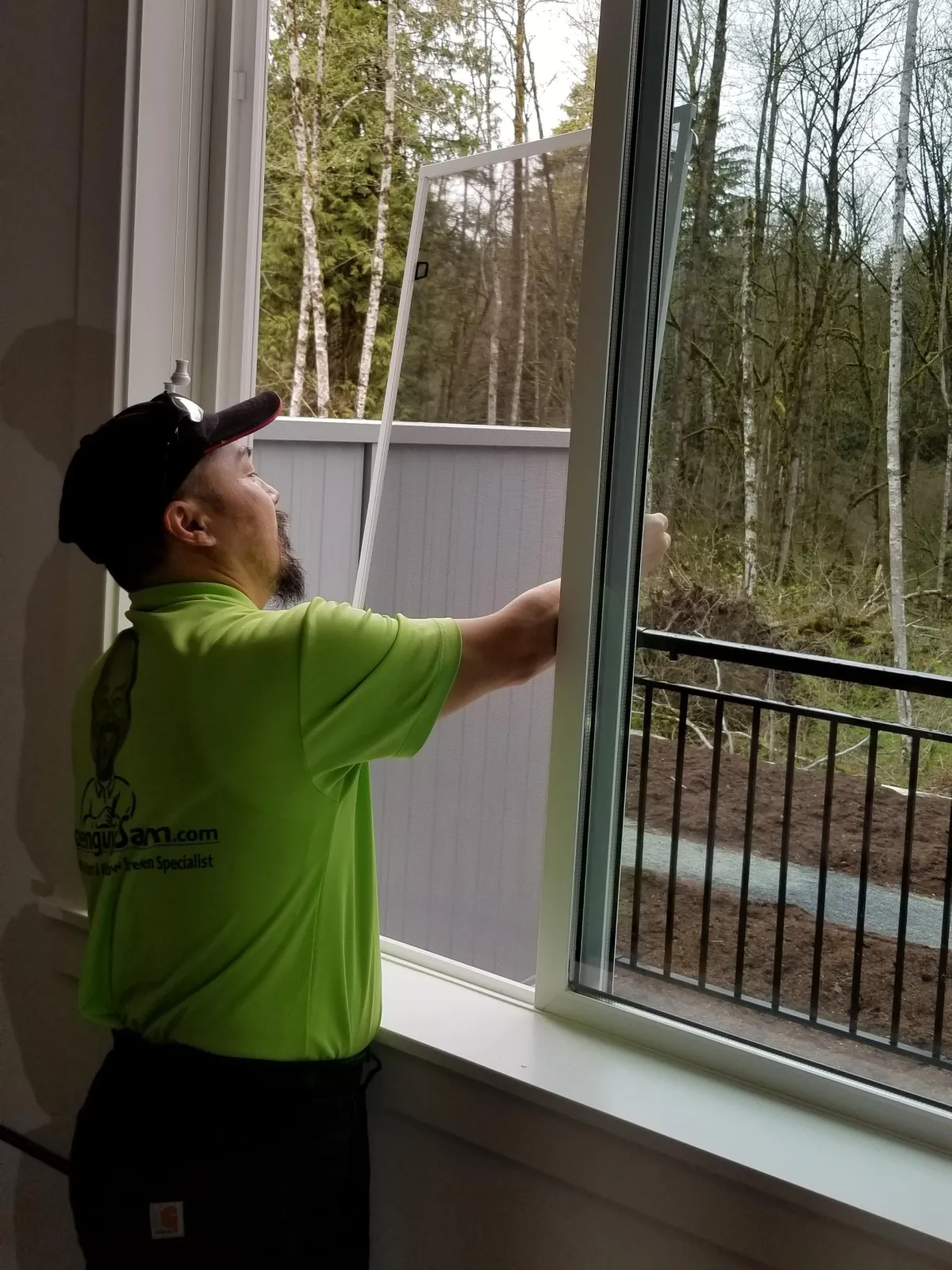 Screenguy Sam installing a sliding window screen at a townhome.