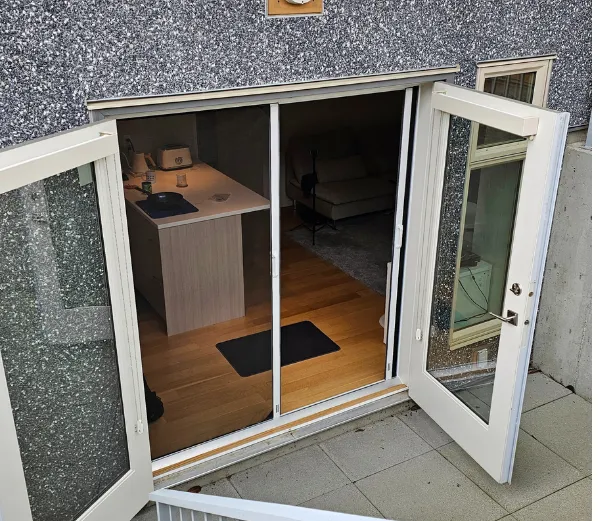 Example of how you can keep one retractable screen door closed while keeping other opened for convenience in an basement in Langley 
