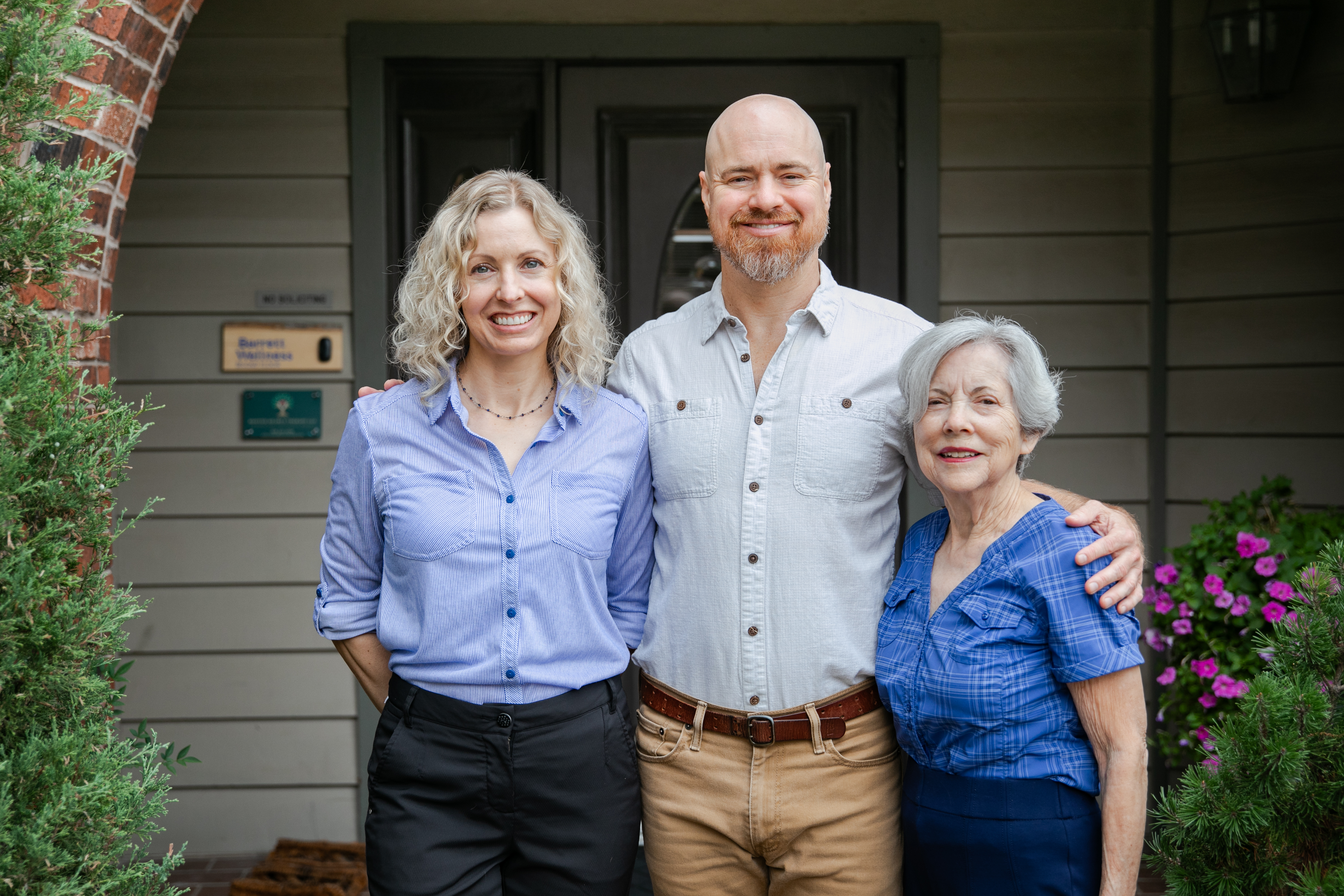 Man exercising on a leg press machine with a female trainer assisting, demonstrating personalized exercise therapy at ZOVA Chiropractic Rehab Center.