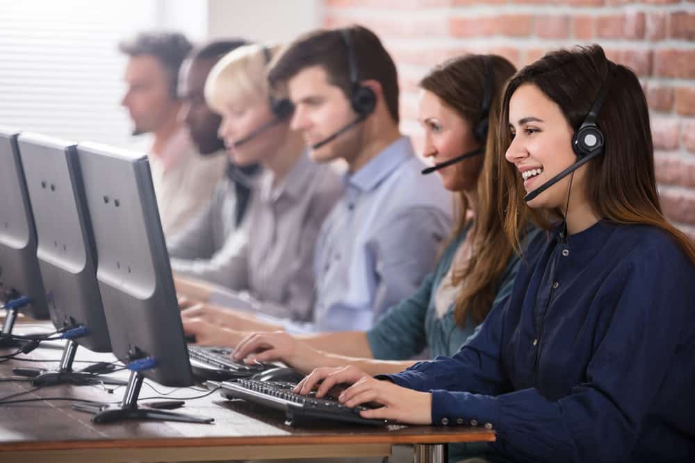 Call center agents wearing headsets, representing a traditional legal answering service.