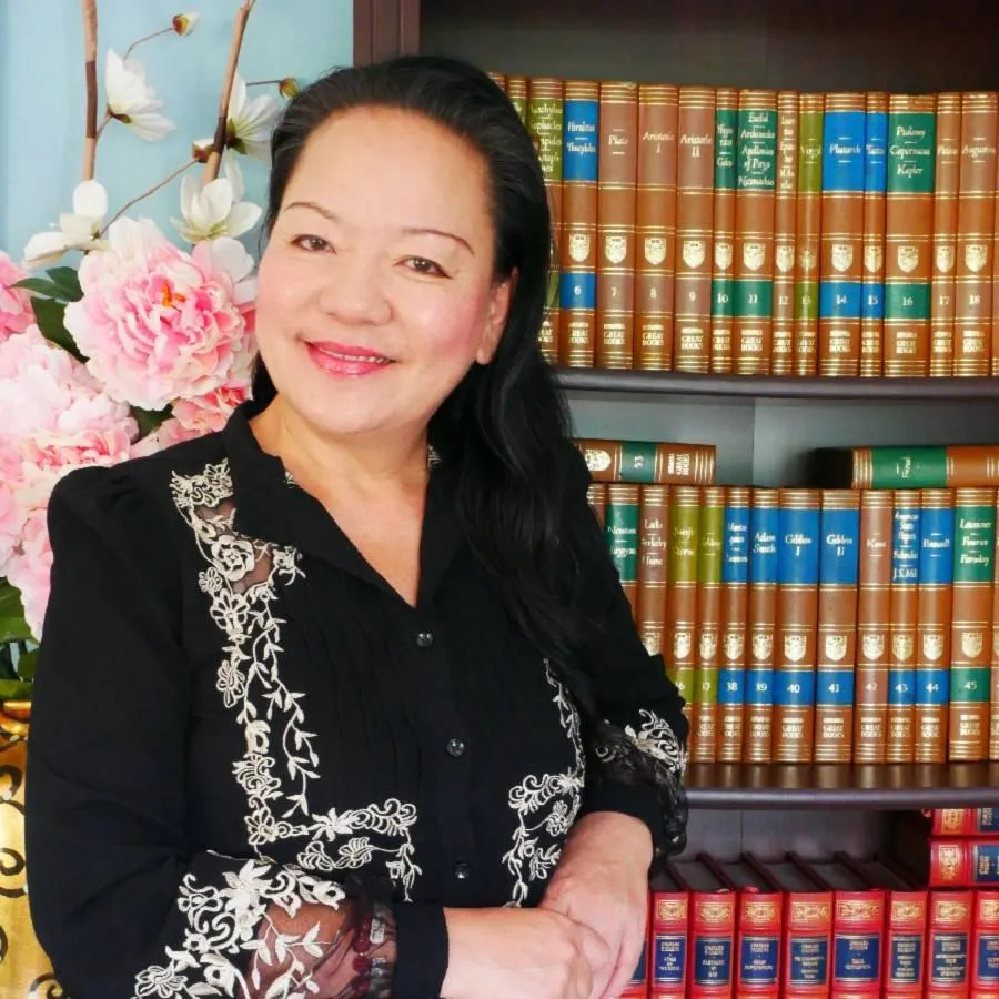 A serene, modern family of four—parents and two children—sitting together on a light wooden floor, surrounded by soft natural light, practicing gentle breathing exercises in a minimalist living room. The scene radiates calm, unity, and holistic well-being.