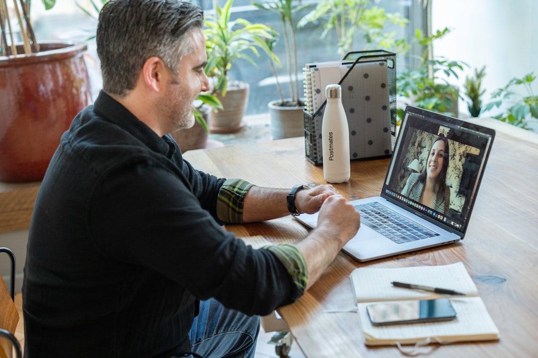 three person pointing the silver laptop computer