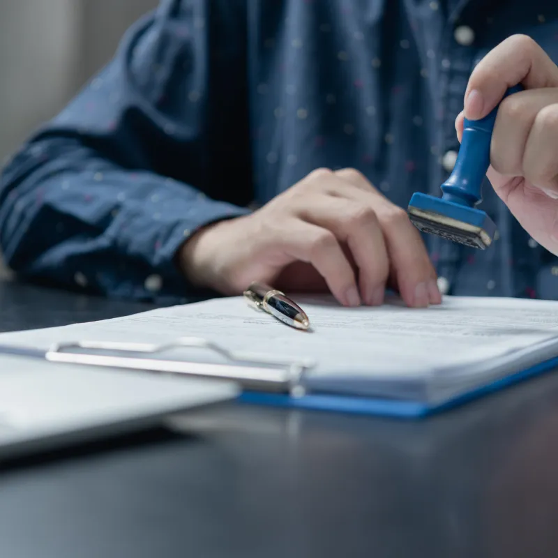 a woman writing on a piece of paper