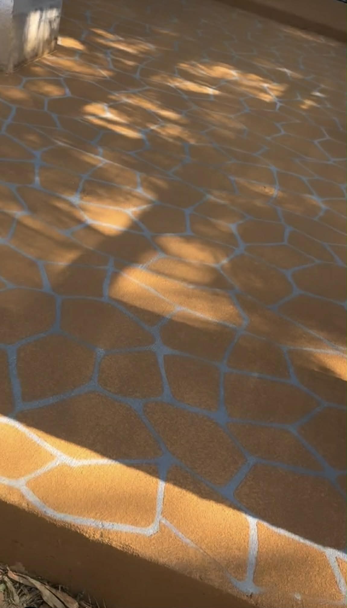 surface painted outdoor floor with golden brown base and grey cracks spray paved