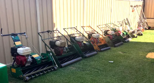 a photo of 5 cylendar lawn mowers, edger and whippersnipers