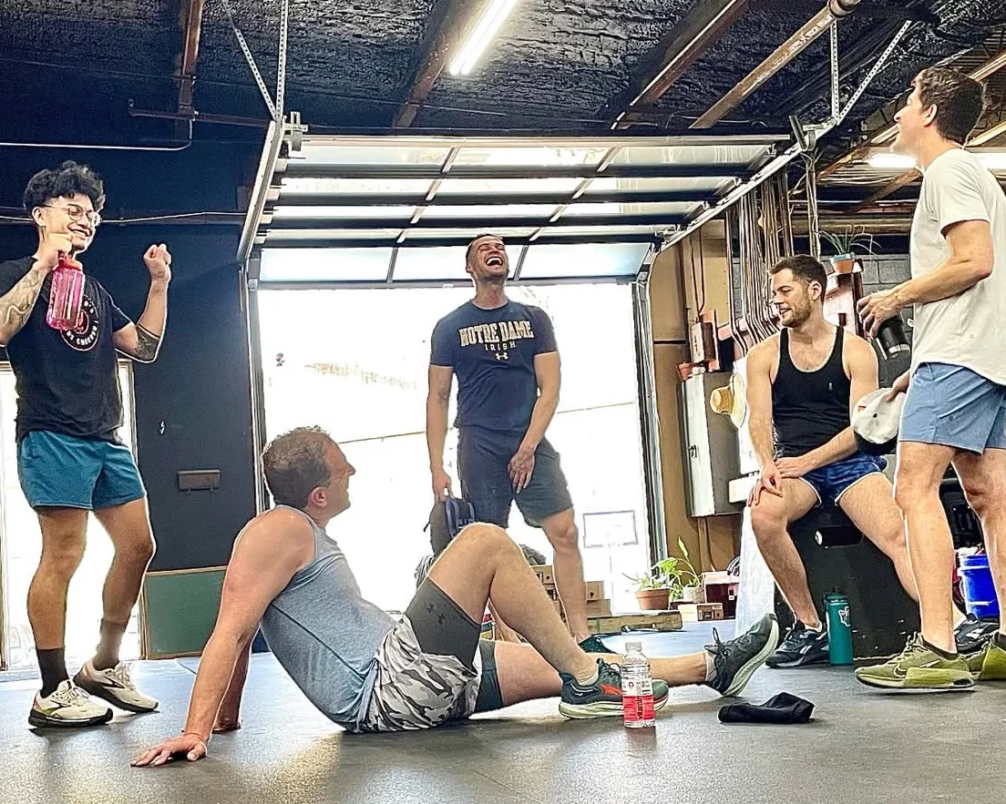 Gym members laughing together after a strenght and conditioning class at Phys. Ed. in East Point, GA