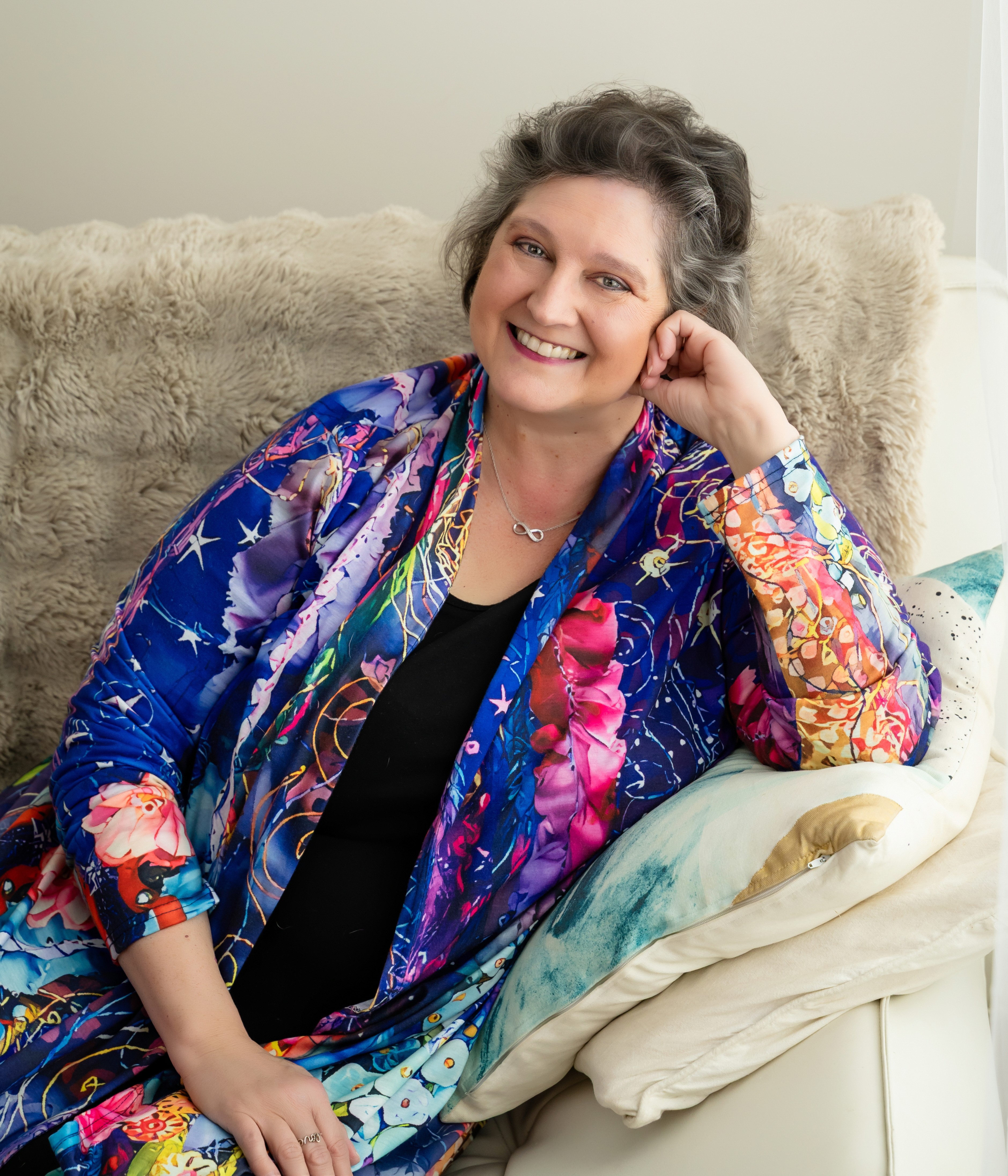 woman in colourful jacket smiling