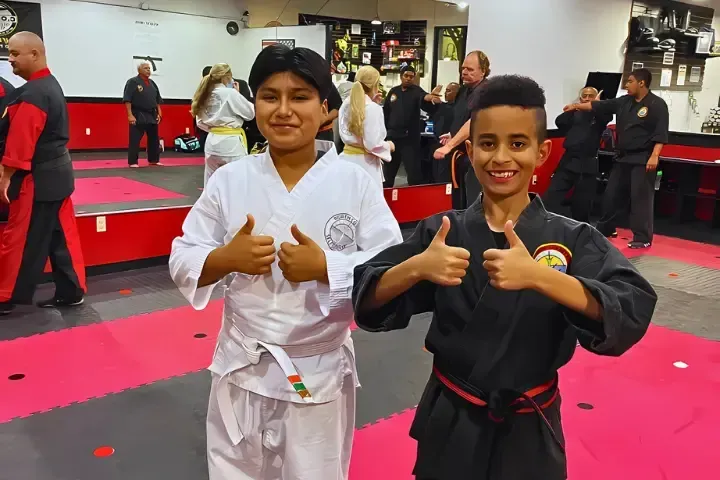 Children practicing martial arts techniques in a class at Kees Tae Kwon Do