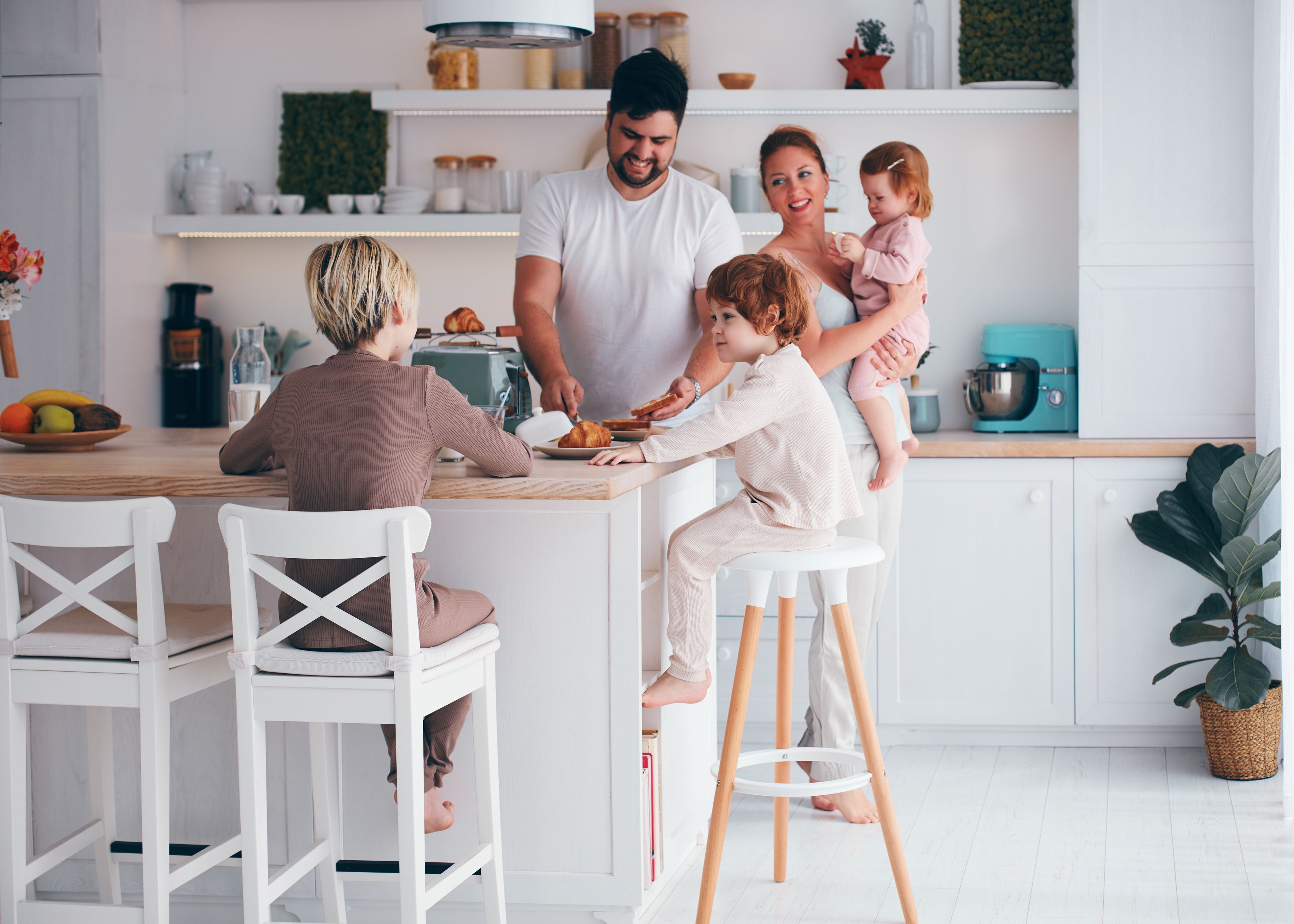 Family at home in kitchen, enjoying knowing their home and family are protected