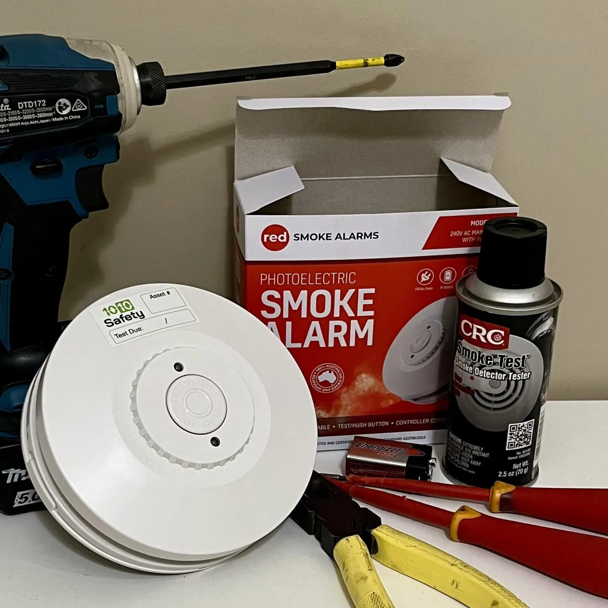 High-quality photoelectric smoke alarm and electrical tools ready for professional installation in a Dubbo strata plan.