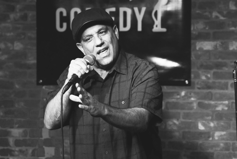 Comedian Mike Muratore on stage doing crowd work