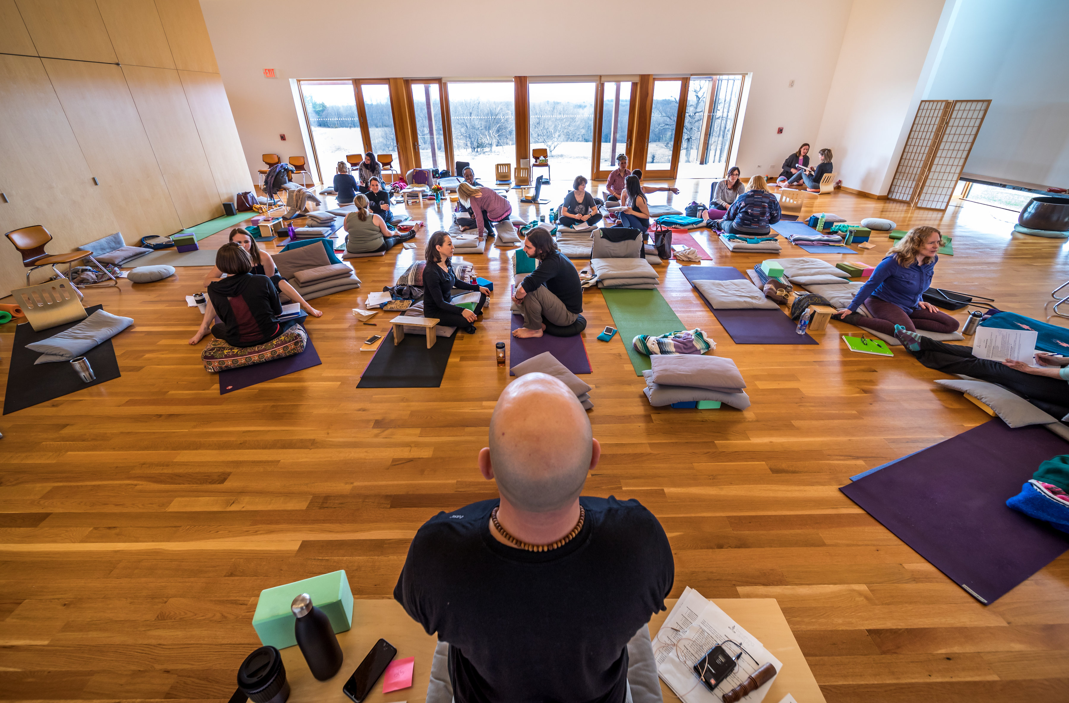 person in blue shorts sitting on beach shore during daytime