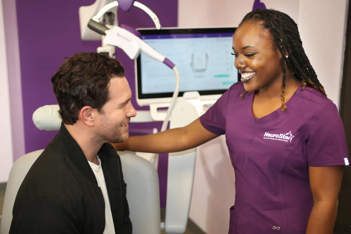 silhouette of woman sitting by the seashore during sunset