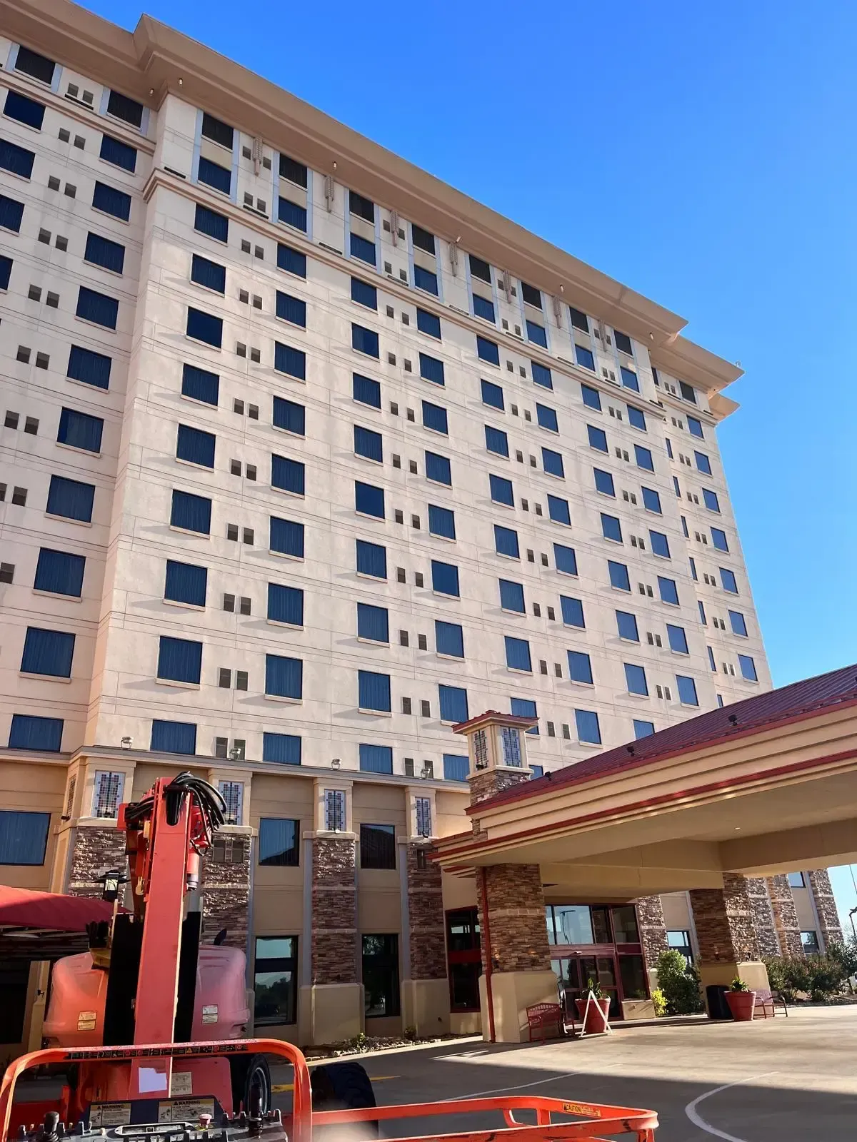 High-rise hotel building with professional window cleaning equipment in Oklahoma City - Suds Monkey commercial window cleaning services