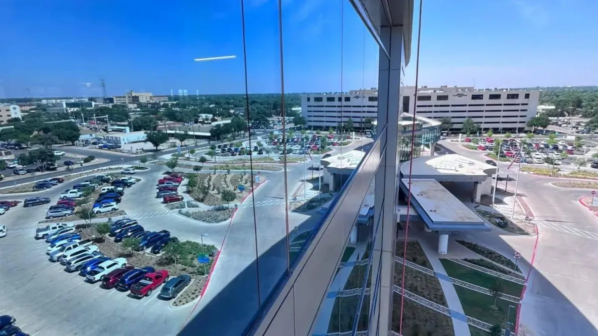 High-rise window cleaning services Oklahoma City - spotless commercial windows overlooking OKC business district and parking areas