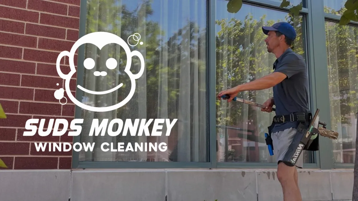 Oklahoma City window cleaner professionally cleaning residential windows with squeegee