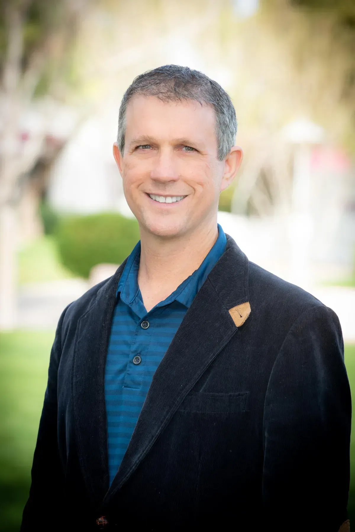 A classroom with tables and chairs and a whiteboard