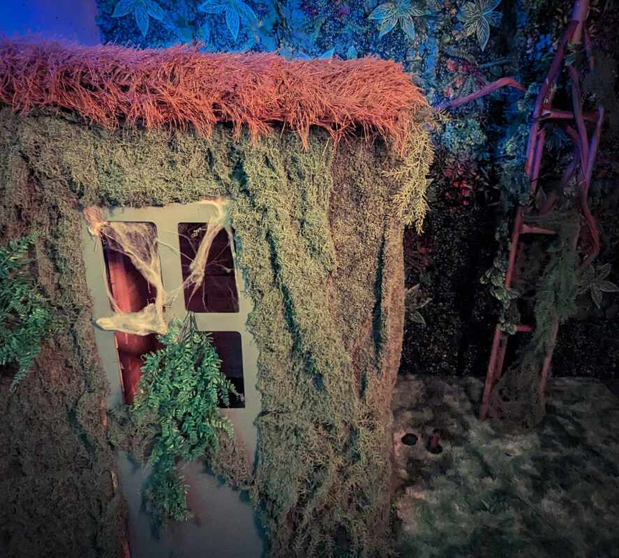 a dimly lit room with tables and chairs