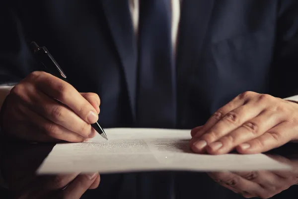 College football player with parents and attorney reviewing documents