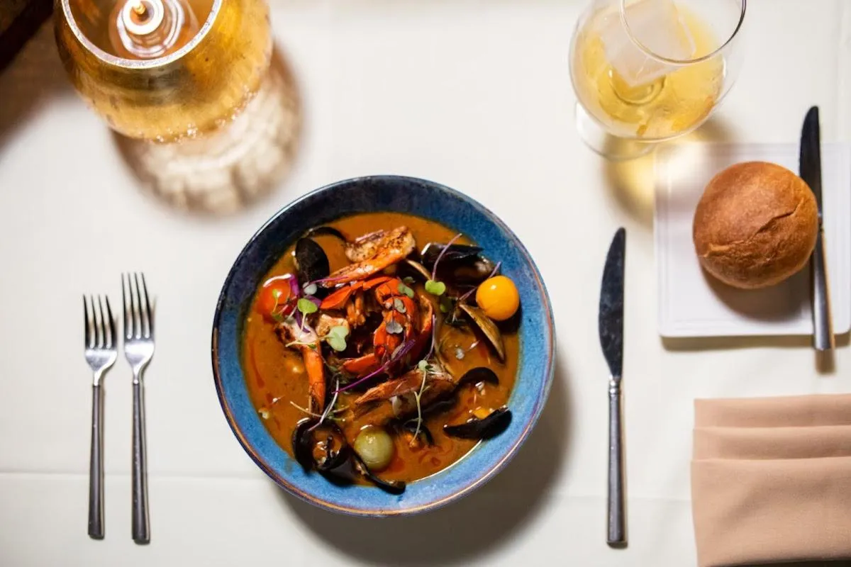 A woman in a blue dress standing in front of a stage