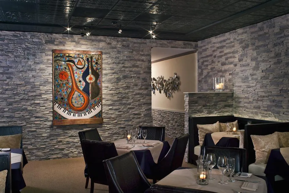 A woman in a blue dress standing in front of a stage